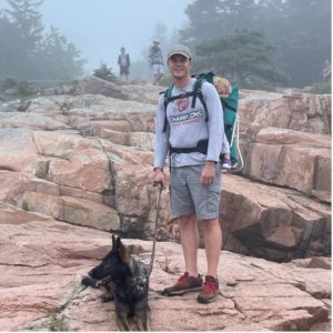 Man on hike with dog and baby